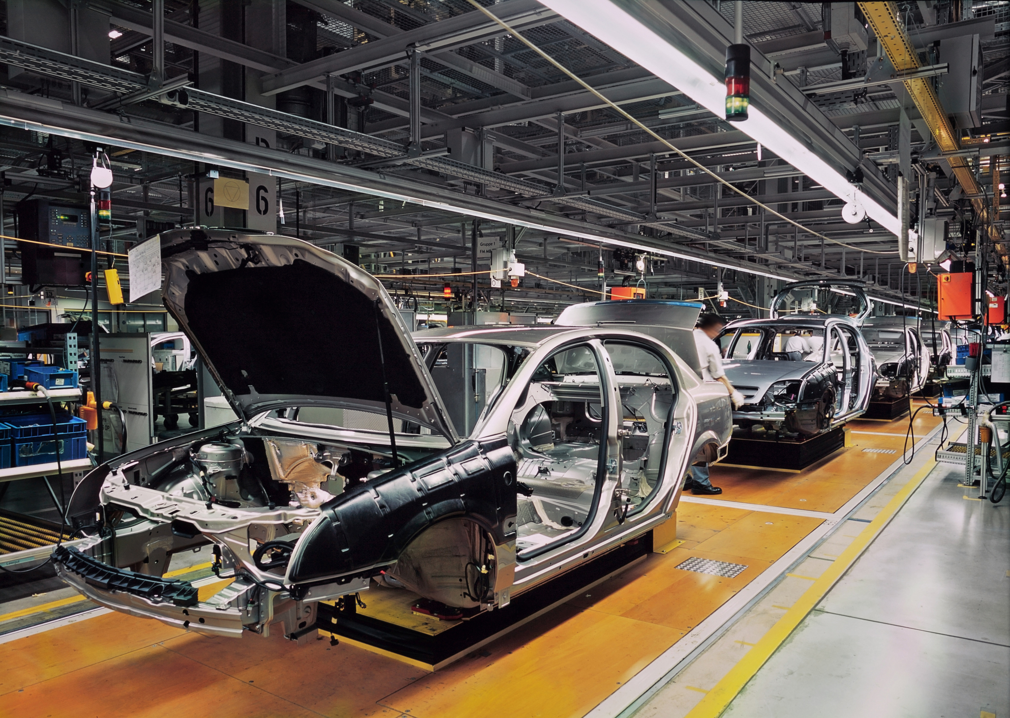 car production line with unfinished cars in a row