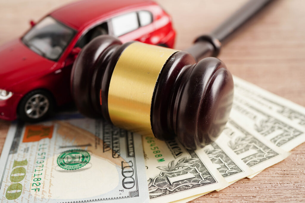 Car accident lawsuit and insurance, Judge hammer and money with car model. how-hard-is-it-to-win-a-Lemon-Law-claim