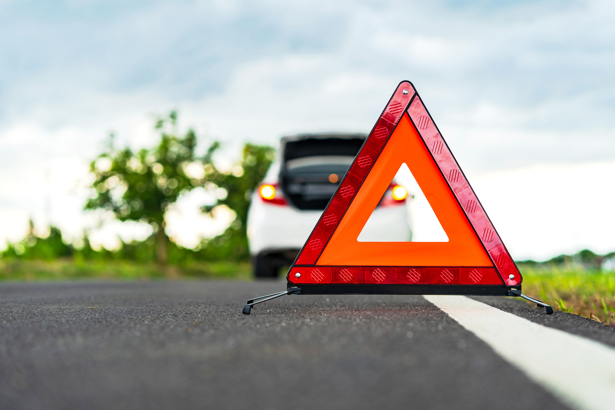 Close-Up Of Red Road Sign On Road Against Sky