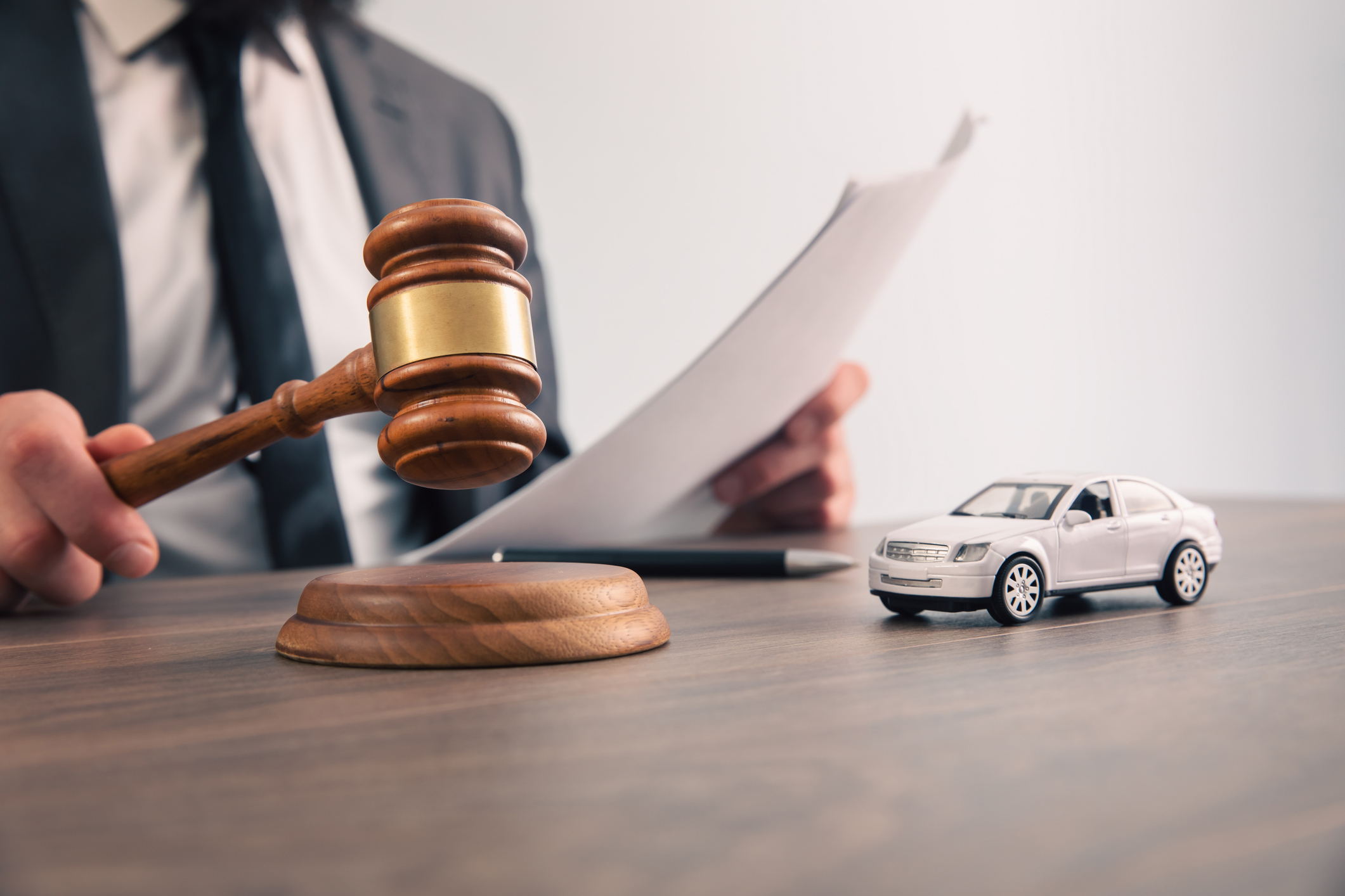 Model of car and gavel. Accident lawsuit or insurance
